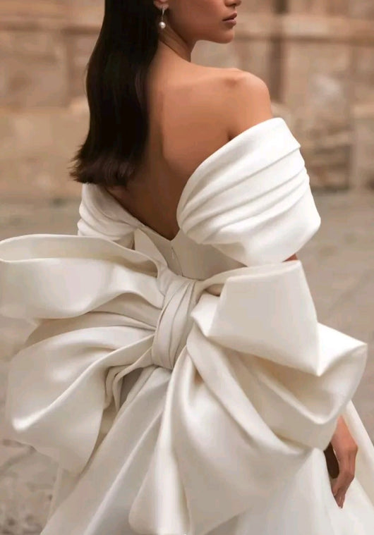 Ellegant off shoulder wedding dress. Satin bow back bridal gown.
